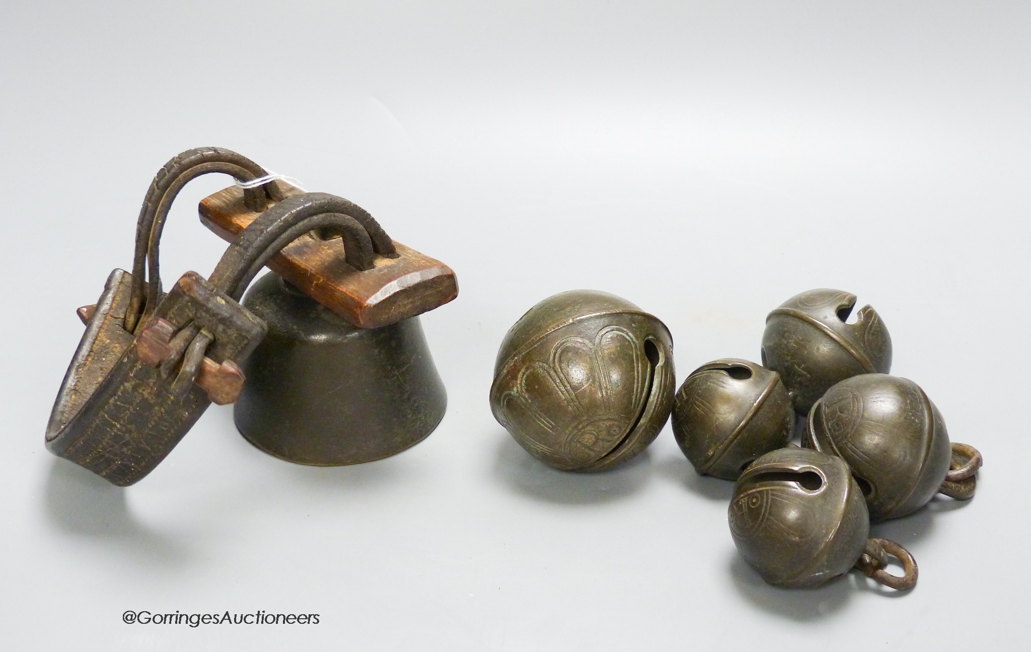 Five 18th century bronze crotal bells, by Robert Wells of Aldbourne, Wiltshire, numbered 3,4 and 8 and an 18th / 19th century livestock bell, numbered 16